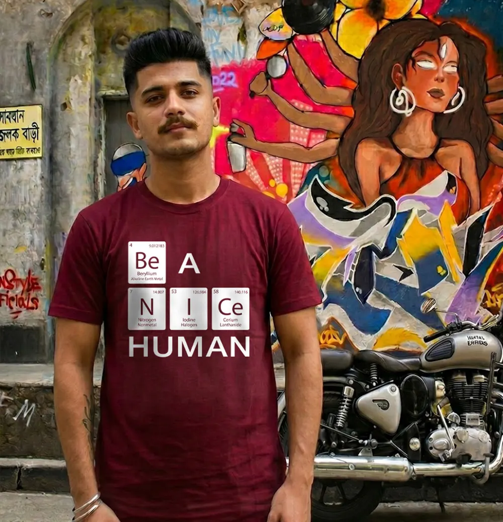 Man wearing Be A Nice Human T-shirt and standing