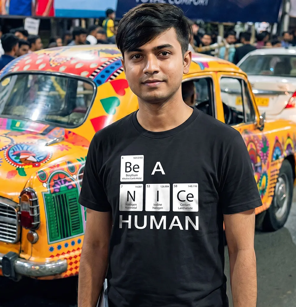 Man wearing Be A Nice Human T-shirt and standing