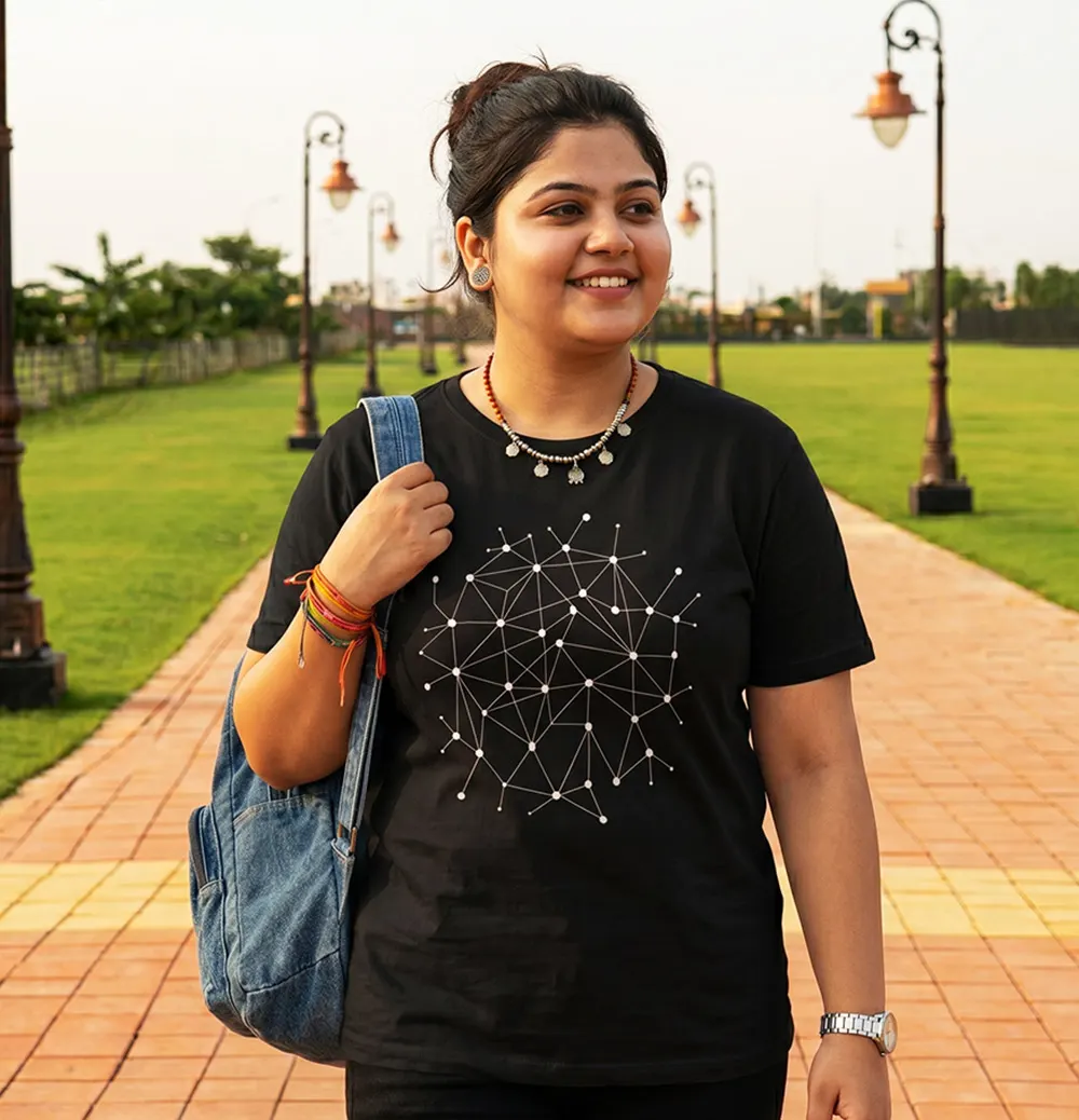 Man wearing a black atom graphic T-shirt while walking outdoors