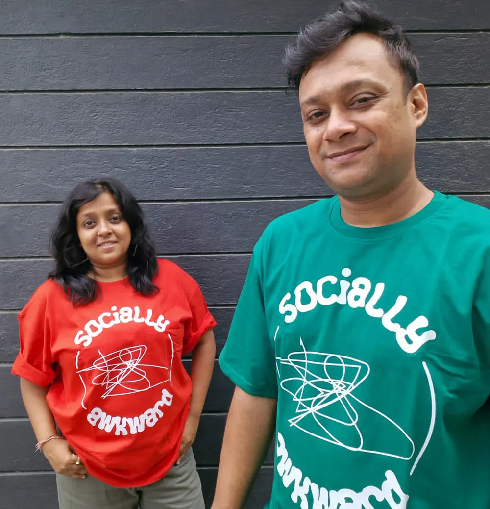 Couple wearing matching Socially Awkward T-shirts